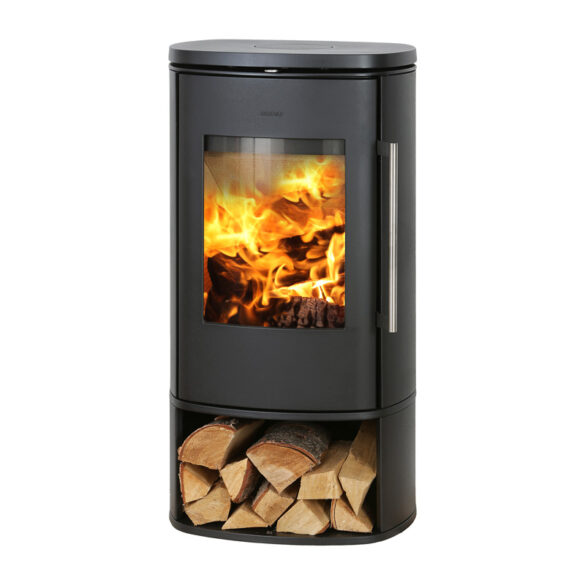 Black freestanding wood stove with a glass front showing bright flames and a storage shelf filled with split logs beneath